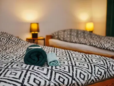 a bed with two beds with towels on it at Apartament Bazylek, miejsce parkingowe w garażu podziemnym in Kraków