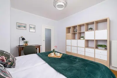 a bedroom with a bed with a tray on it at Przytulny i Przestronny Apartament w Krakowie z Parkingiem Biurkiem i 2 Balkonami by Noclegi Renters in Kraków