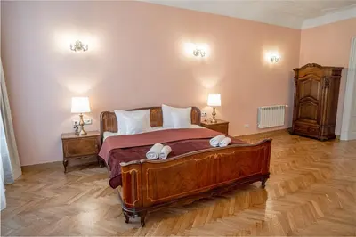 a bedroom with a large wooden bed with stuffed animals on it at Apartamenty pod Jagnięciem - Rynek Główny in Kraków