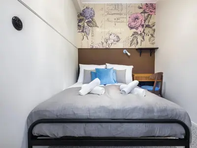 a bedroom with a large bed with blue pillows at Kalwaryjska by Tyzenhauz in Kraków