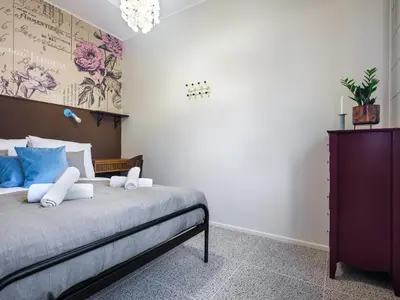 a bedroom with a large bed with blue pillows at Kalwaryjska by Tyzenhauz in Kraków
