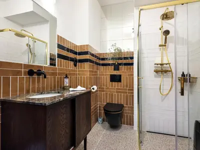 a bathroom with a sink and a shower at Kalwaryjska by Tyzenhauz in Kraków