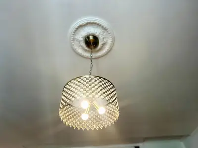 a glass light fixture hanging from a ceiling at Vintage Senacka 3 Apartment in Kraków