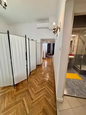 a hallway with a row of stalls in a room at Vintage Senacka 3 Apartment in Kraków
