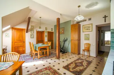 a kitchen and dining room with a table and chairs at Painter's house in Kraków