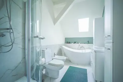 a bathroom with a tub and a toilet and a sink at Painter's house in Kraków