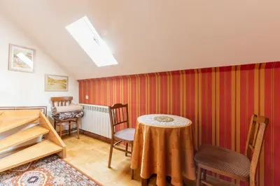 a room with a table and chairs in a room at Painter's house in Kraków