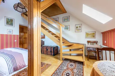 a bedroom with a loft bed and a staircase at Painter's house in Kraków