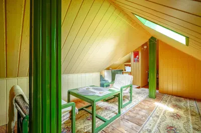 a room with a green table and a chair at Painter's house in Kraków