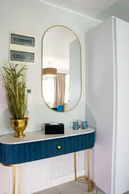 a bathroom with a blue sink and a mirror at Apartment w ogrodzie w sercu starego Krakowa in Kraków