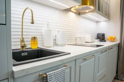 a kitchen with a sink and a counter top at Apartment w ogrodzie w sercu starego Krakowa in Kraków