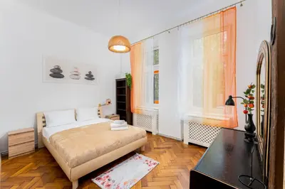 a bedroom with a bed with towels on it at Park Strzelecki Spacious Apartment by BookingHost in Kraków