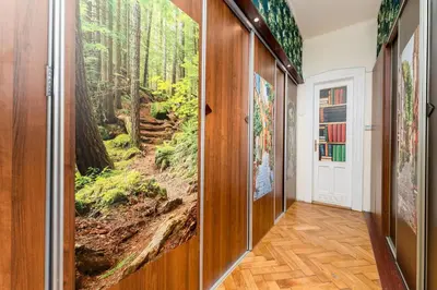 a hallway with a wall mural of a forest at Park Strzelecki Spacious Apartment by BookingHost in Kraków