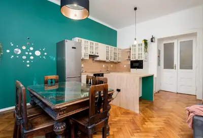 a kitchen with a table and a refrigerator at Park Strzelecki Spacious Apartment by BookingHost in Kraków