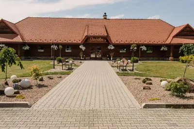 a building with a brick walkway in front of it at Centrum Aktywnego Wypoczynku Borek in Rzezawa