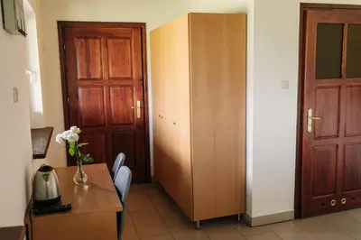 a room with a door and a table with a vase of flowers at Centrum Aktywnego Wypoczynku Borek in Rzezawa