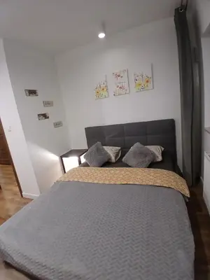 a bedroom with a large bed with two pillows at Cracow Stay Inn Home in Kraków