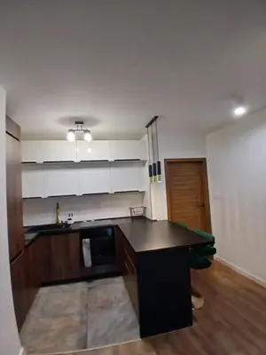 a kitchen with a black counter top in a room at Cracow Stay Inn Home in Kraków