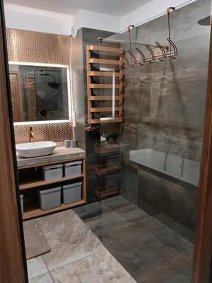 a bathroom with a shower and a sink and a tub at Cracow Stay Inn Home in Kraków