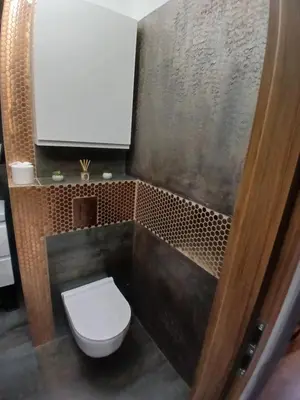 a small bathroom with a toilet and a shower at Cracow Stay Inn Home in Kraków