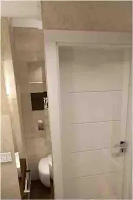 a bathroom with a white door and a toilet at Family Modern apartment 35m2-for Max 5 persons in Kraków
