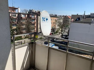 a satellite dish sitting on top of a building at Family Modern apartment 35m2-for Max 5 persons in Kraków