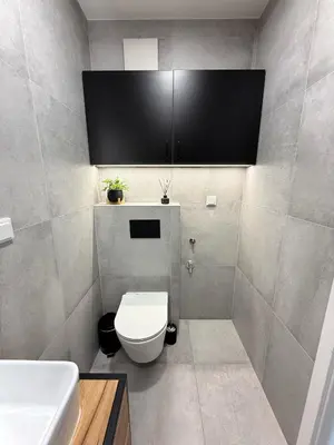 a bathroom with a white toilet and a sink at Halicka Apartment Free Parking by CityBeat in Kraków