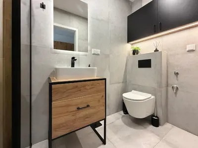 a bathroom with a sink and a toilet at Halicka Apartment Free Parking by CityBeat in Kraków