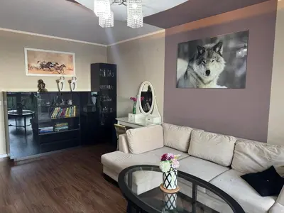 a living room with a wolf picture on the wall at Supreme Luxury Apartment in Kraków