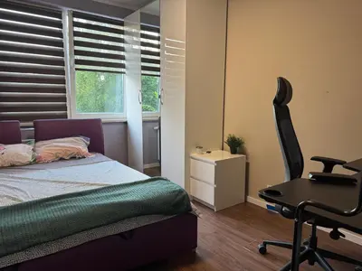 a bedroom with a bed and a desk and a chair at Supreme Luxury Apartment in Kraków
