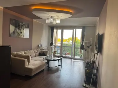 a living room with a couch and a table at Supreme Luxury Apartment in Kraków