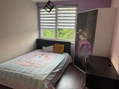 a small bedroom with a bed and a window at Supreme Luxury Apartment in Kraków