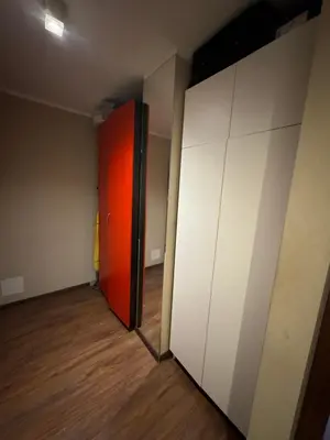 an empty room with a red door and white walls at Supreme Luxury Apartment in Kraków
