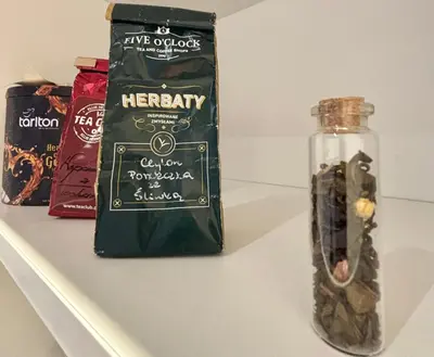 a bottle of herrity on a shelf next to a bag of candy at The Vinci Residence, Kraków Old Town in Kraków