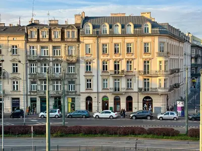 a large building with cars parked in front of it at The Vinci Residence, Kraków Old Town in Kraków