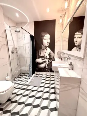 a bathroom with a black and white checkered floor at The Vinci Residence, Kraków Old Town in Kraków