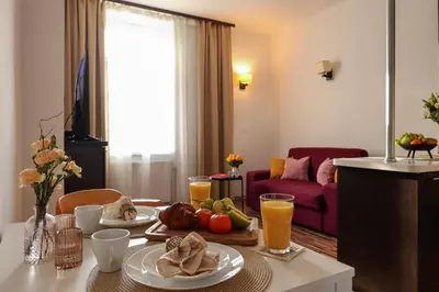 a kitchen with a sink and a table with a wine glass at Sunny Apartment near Krakus Mound in Kraków