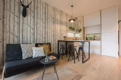 a living room with a couch and a table at Rakowicka Apartment - free parking in Kraków