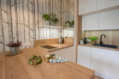 a kitchen with a wooden table with fruit on it at Rakowicka Apartment - free parking in Kraków