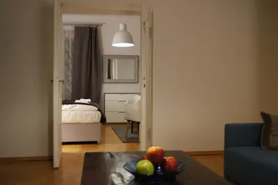 a kitchen with white cabinets and a stove top oven at Apartament Daszyńskiego in Kraków