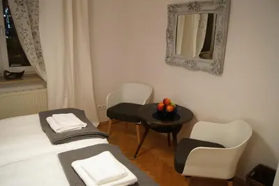 a pair of beds with towels on top of them at Apartament Daszyńskiego in Kraków