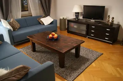 a living room with a door open to a bedroom at Apartament Daszyńskiego in Kraków