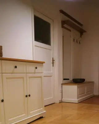 a bedroom with a bed and two chairs and a table at Apartament Daszyńskiego in Kraków