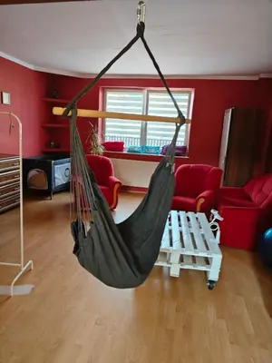 a hammock hanging in a living room at Bramka do lasu in Dąbrowa Górnicza