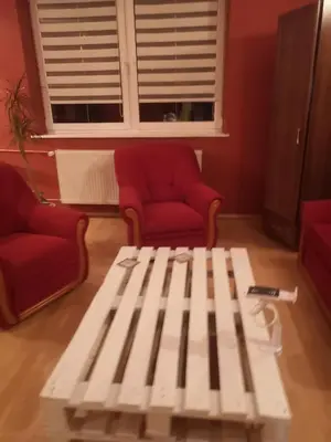 a coffee table in a living room with two chairs and a window at Bramka do lasu in Dąbrowa Górnicza