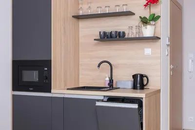 a kitchen with a sink and a microwave at Modern Studios with Air Conditioning in Downtown Kraków by Noclegi Renters in Kraków