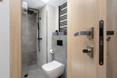 a bathroom with a toilet and a shower stall at Modern Studios with Air Conditioning in Downtown Kraków by Noclegi Renters in Kraków