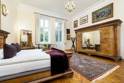 a bedroom with a large bed and a mirror at Efektowny i Przestronny Apartament w Centrum Krakowa Blisko Rynku i Parku by Noclegi Renters in Kraków