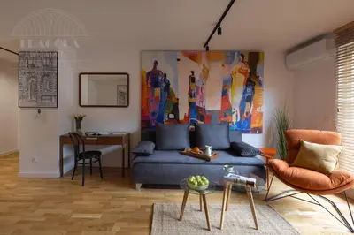 a living room with a couch and a table at Cityscape Fragola Apartments in Kraków