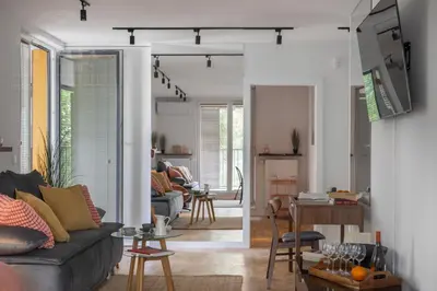 a living room with a couch and a table at Cityscape Fragola Apartments in Kraków